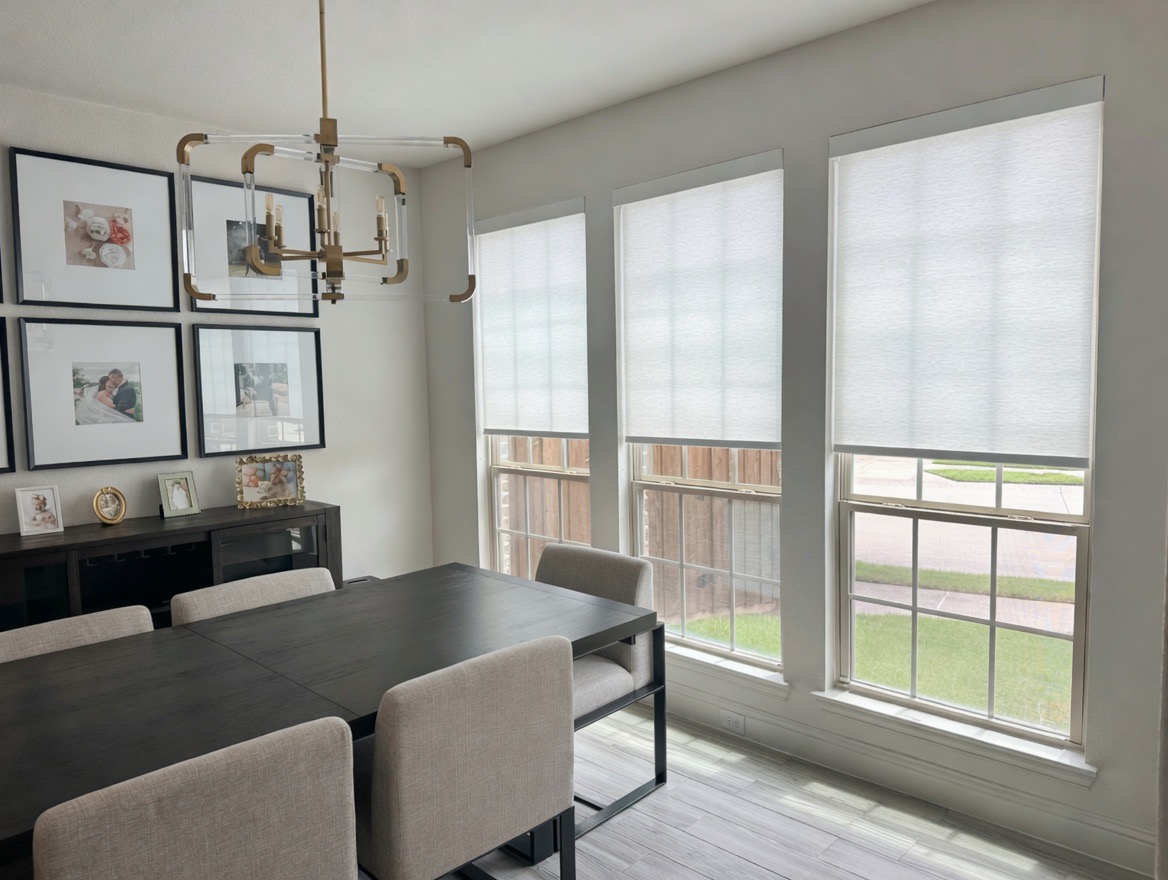 Dining room roller shades lowered partway to control afternoon glare